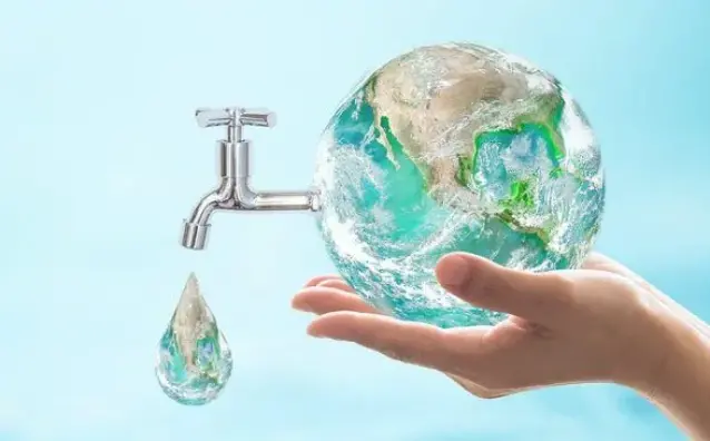 hand holding the world showing a nozzle of water