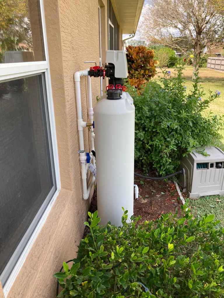 water solution purification system installed outside on the side of a house
