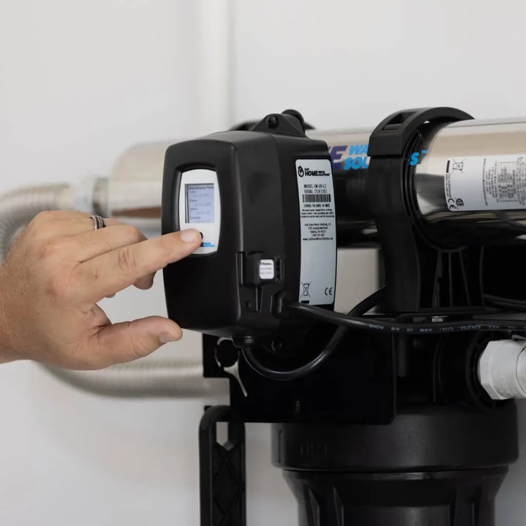 installation expert setting up the digital panel of an in-home water system