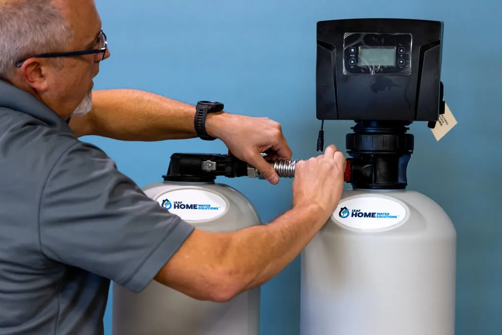 installation expert setting up the connection for an in-home water system