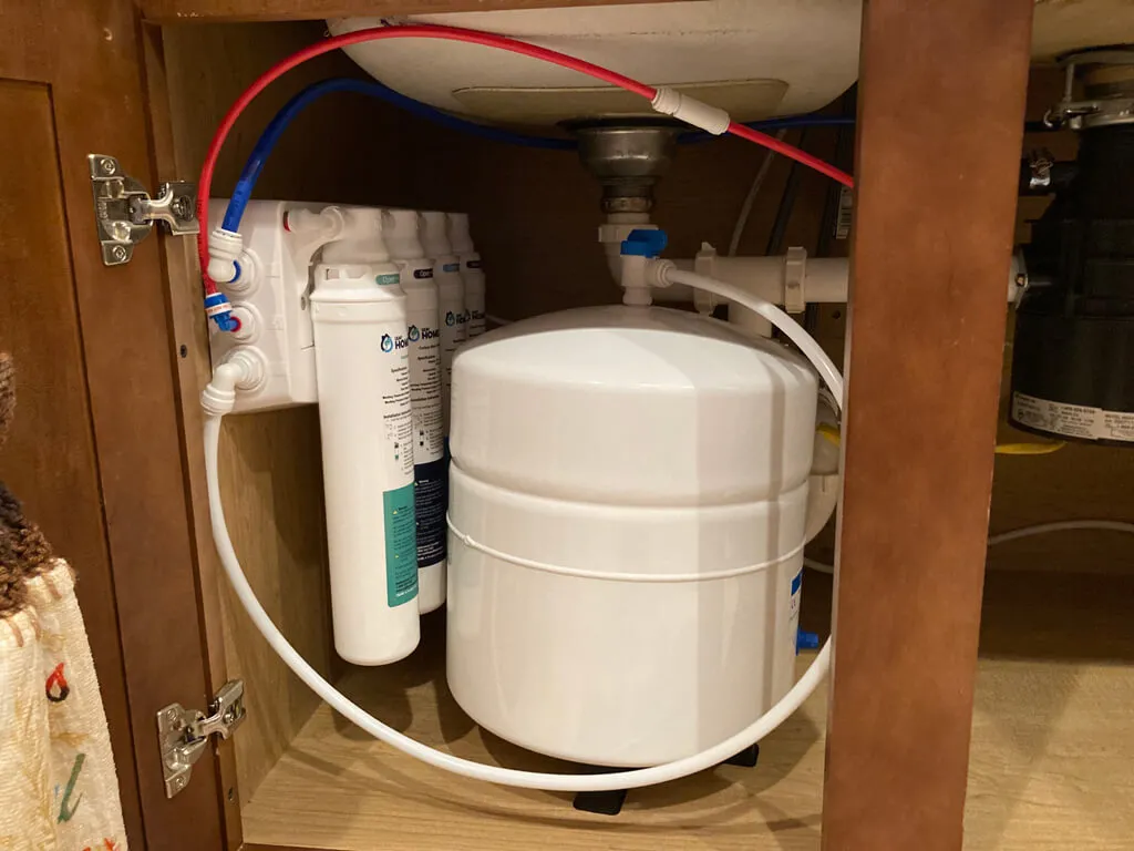 reverse osmosis water system installed beneath a customer's kitchen sink