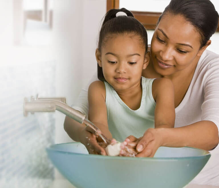 mother and daughter washing hands