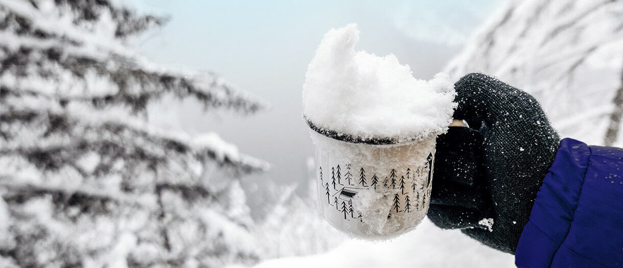 a mug of snow in an outside snowy environment