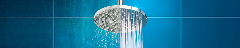 shower head showing the difference between clean running water and dirty clogged water