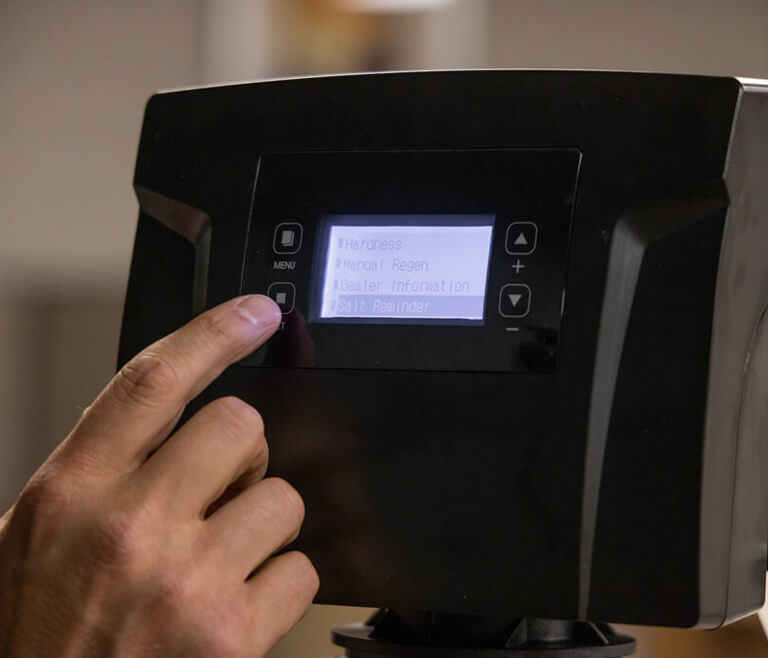 person using a digital screen to setup the in-home water filtration system