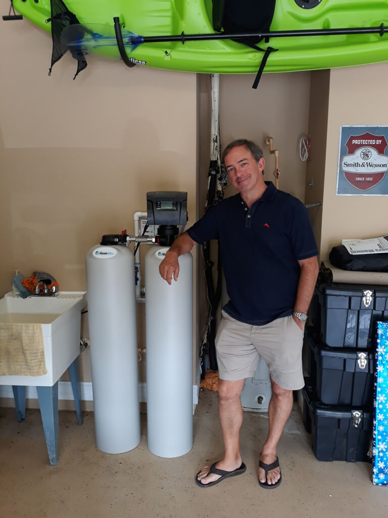 newly installed water treatment system with happy customer