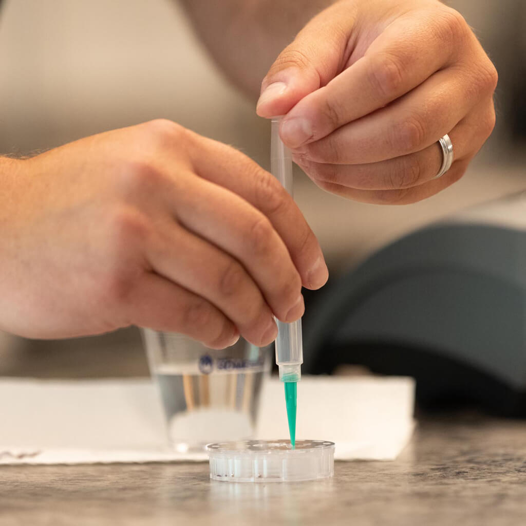 water technician sampling a water test in a customer's home