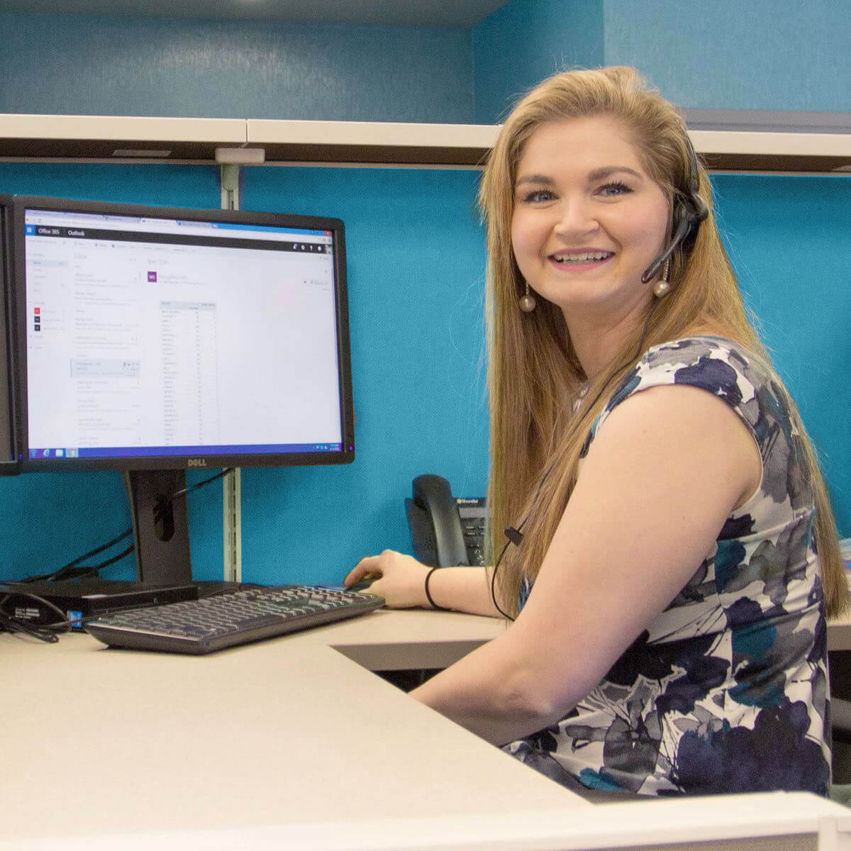 call center representative in front of computer wearing a headset
