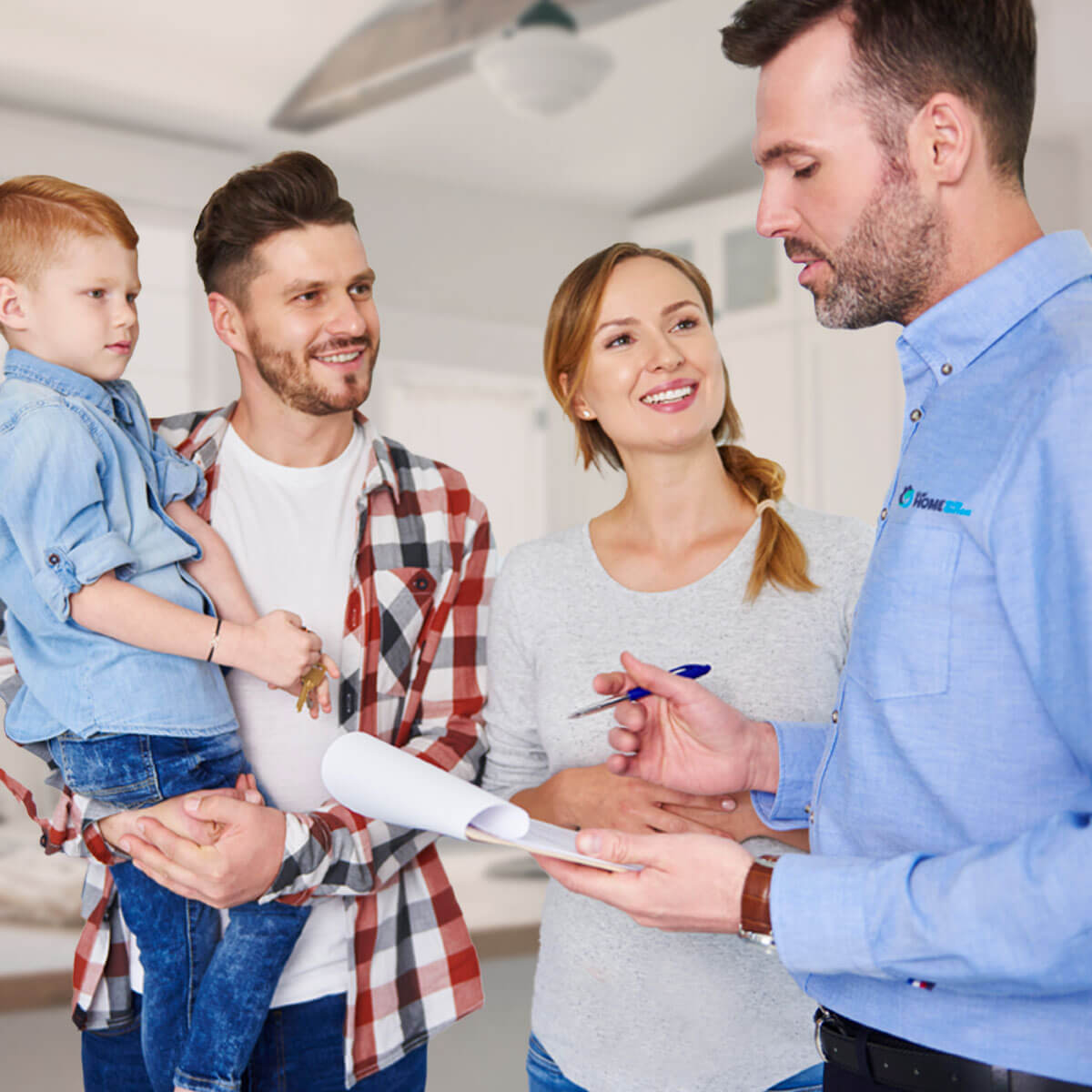 sales team member meeting with wife, husband and child in the kitchen